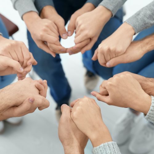 People holding hands together, closeup. Group therapy